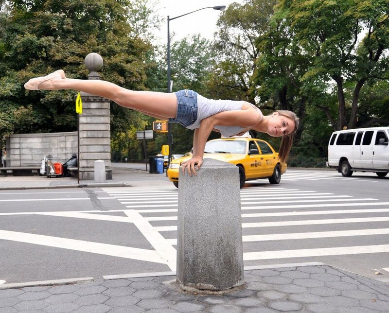 woman doing acrobatic pose on street