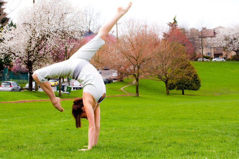 Woman doing handstand in park