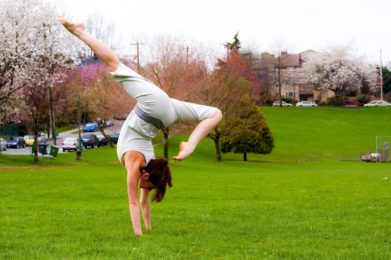 Woman doing handstand in park