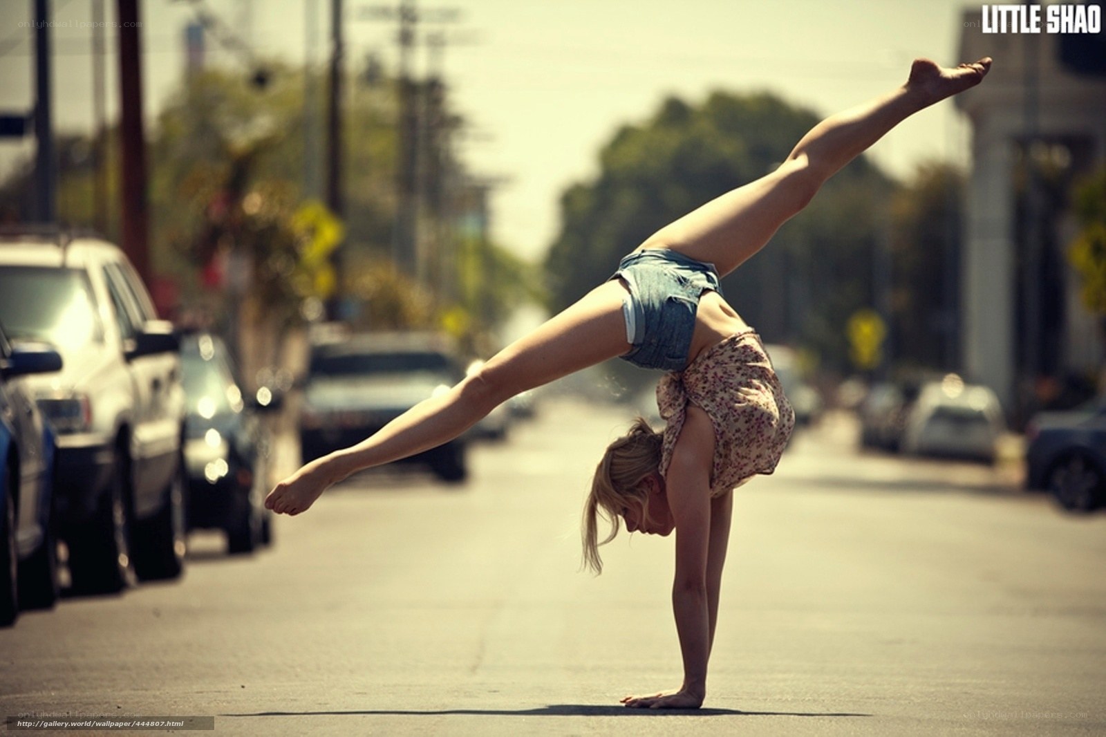 Woman doing handstand on street