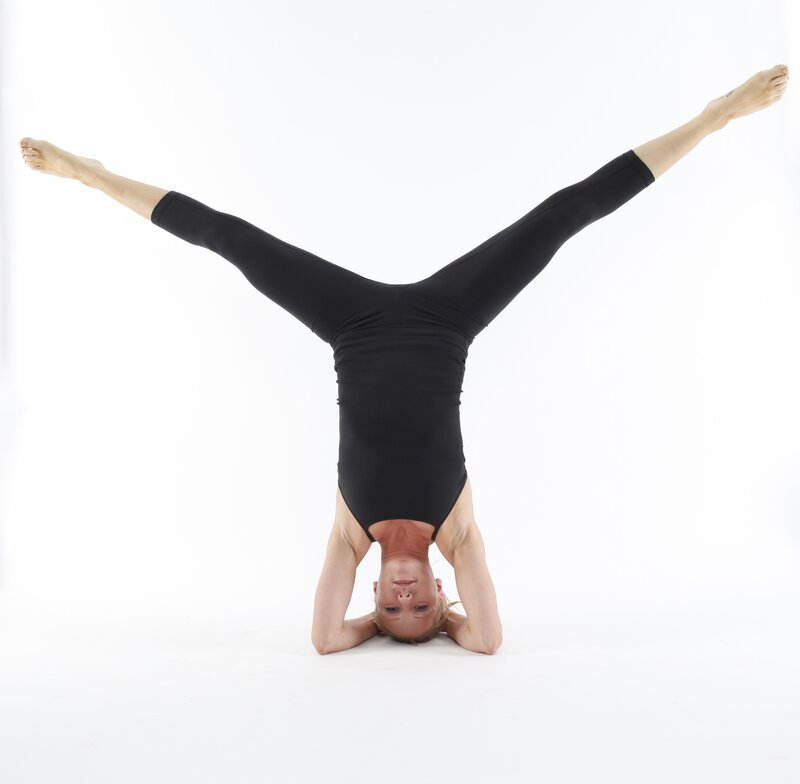 woman doing headstand yoga pose