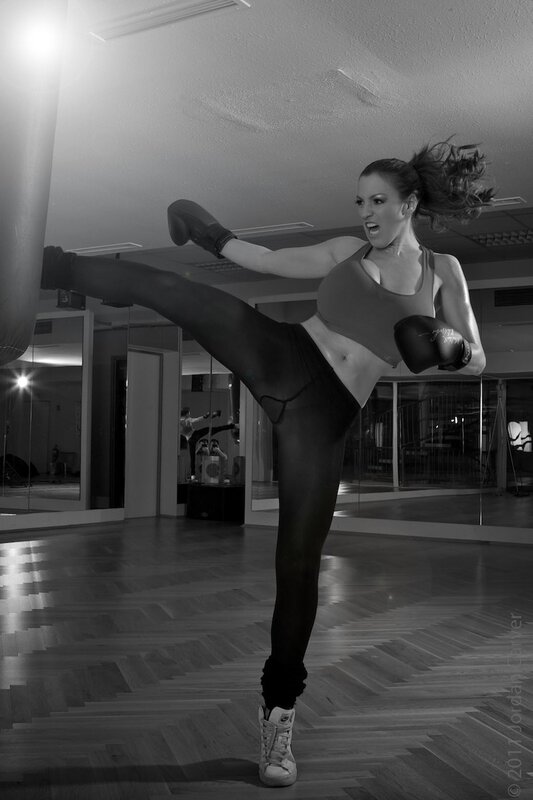 woman doing high kick in gym