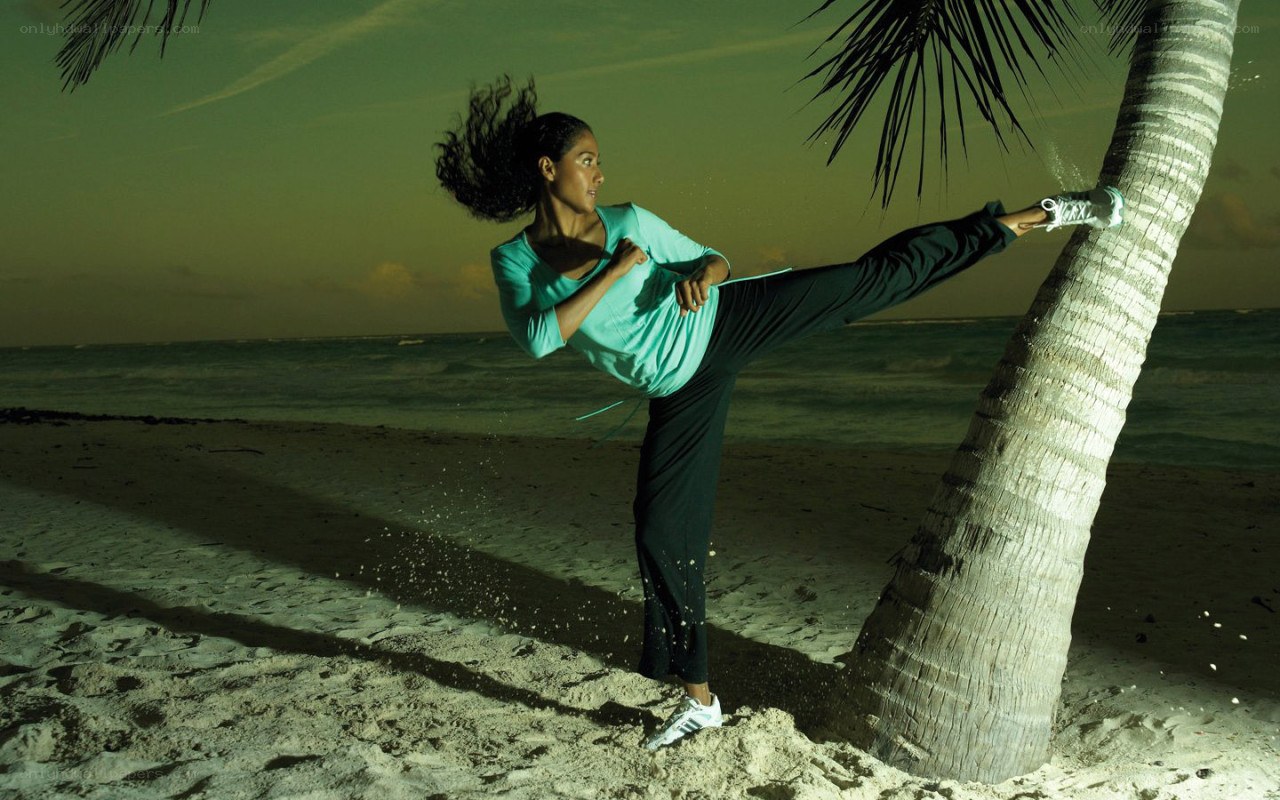 woman doing kick on beach