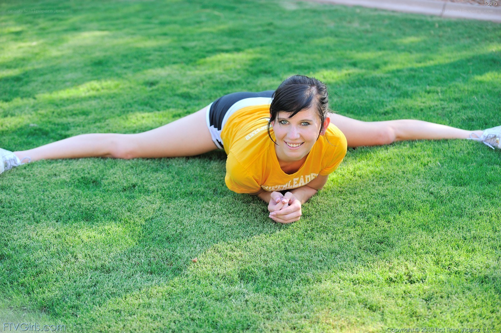 Woman doing splits on grass