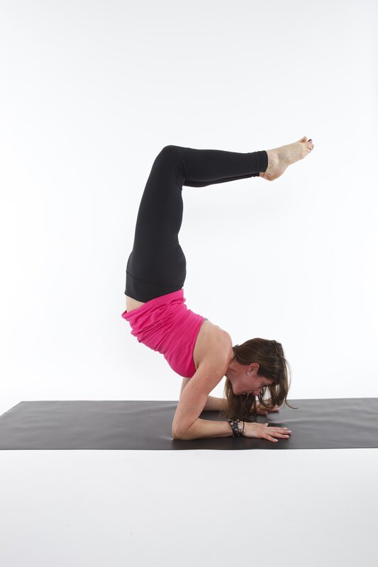 woman doing yoga headstand