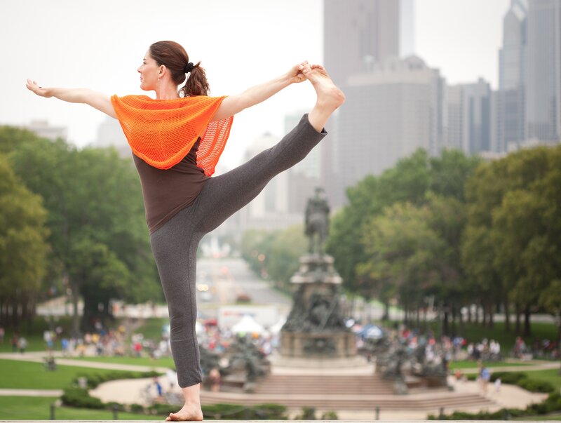 Woman doing yoga in city park