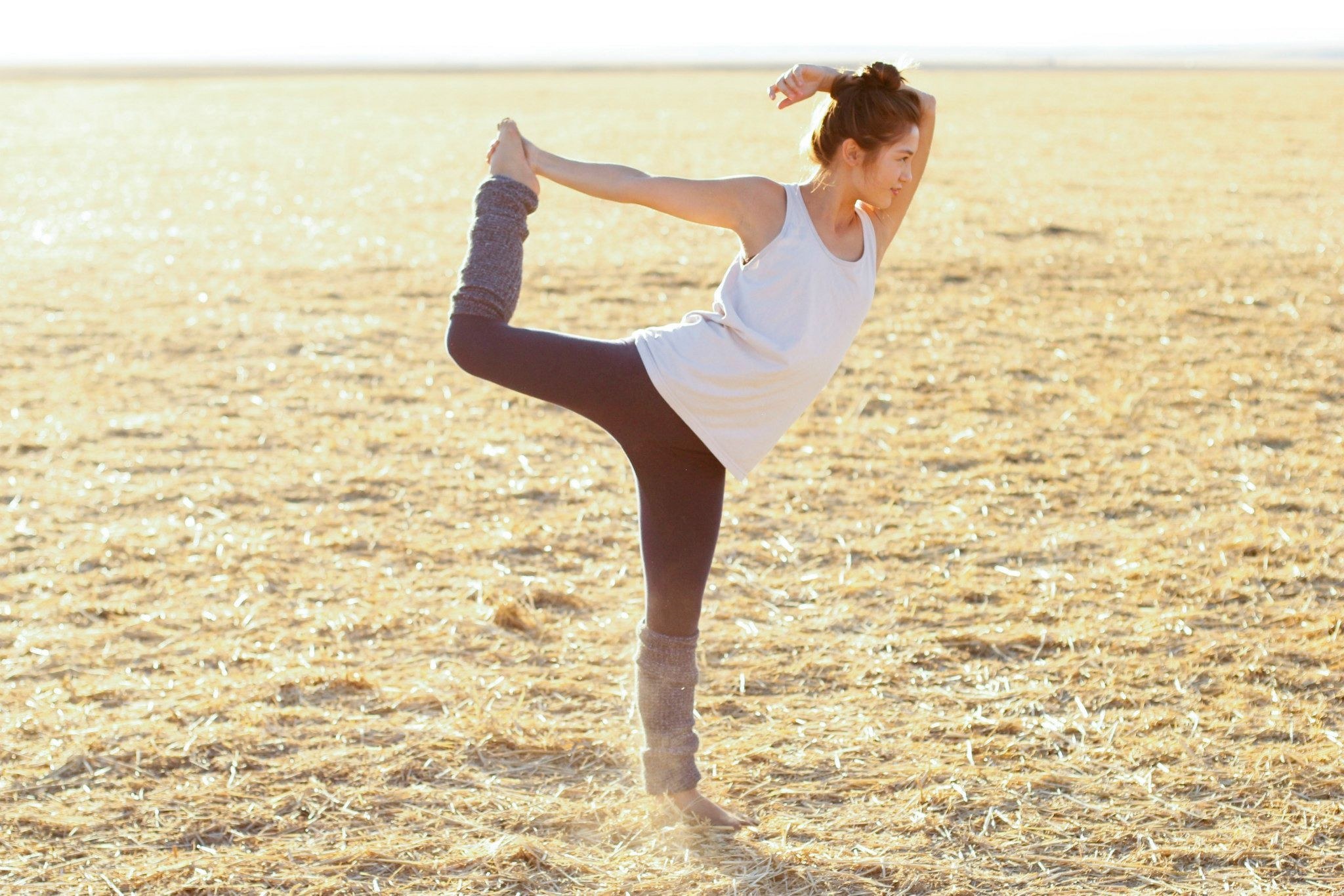 woman doing yoga in field