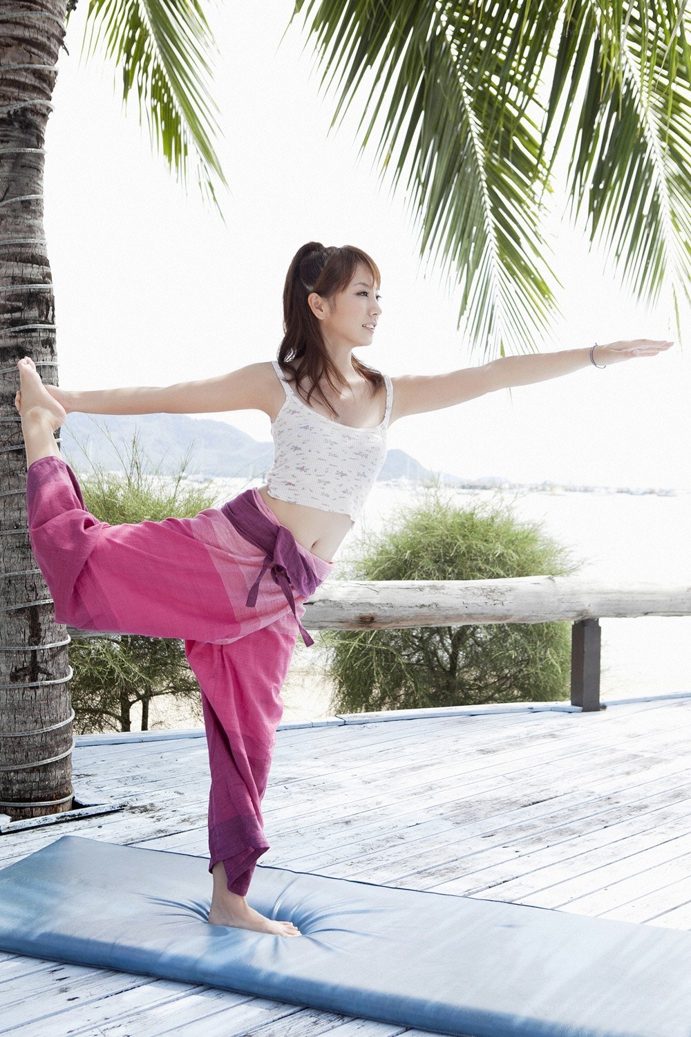 Woman doing yoga on a deck