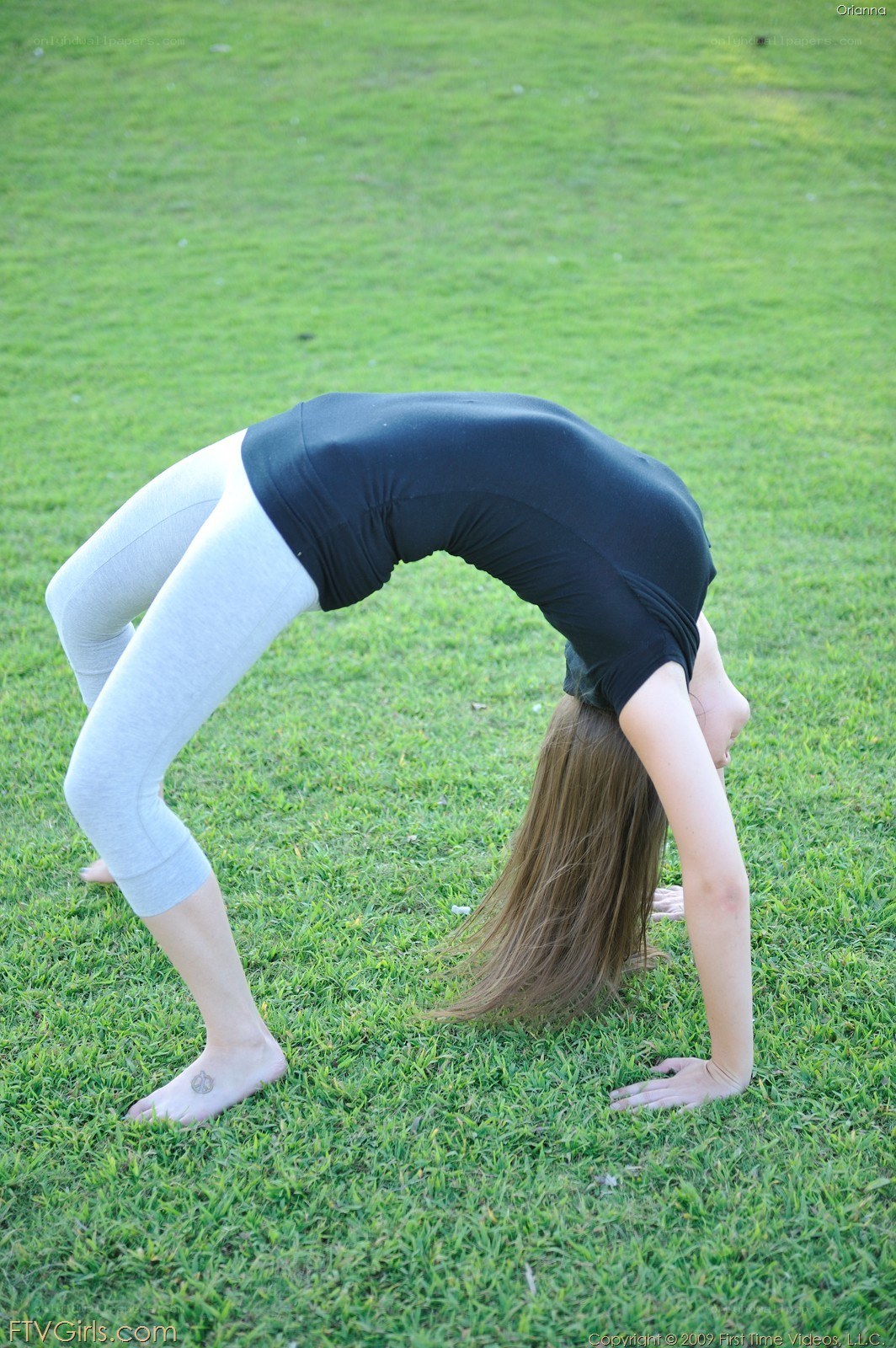woman doing yoga on grass