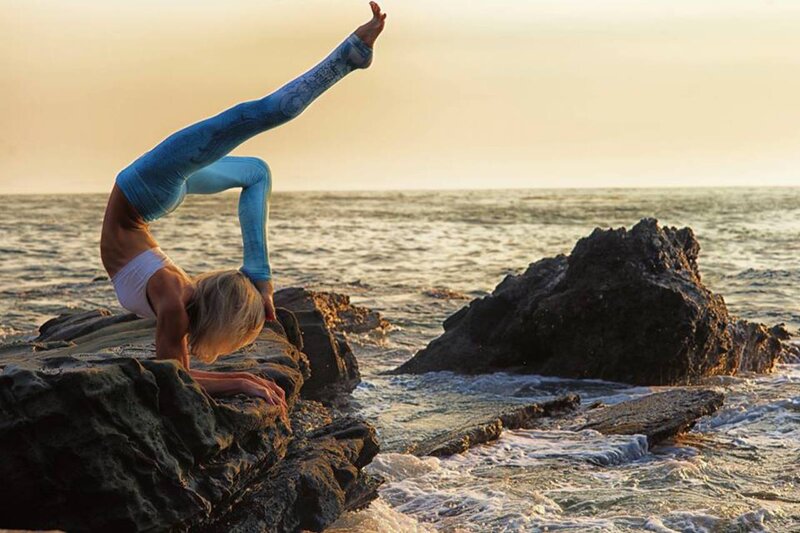 Woman Doing Yoga on Rocks