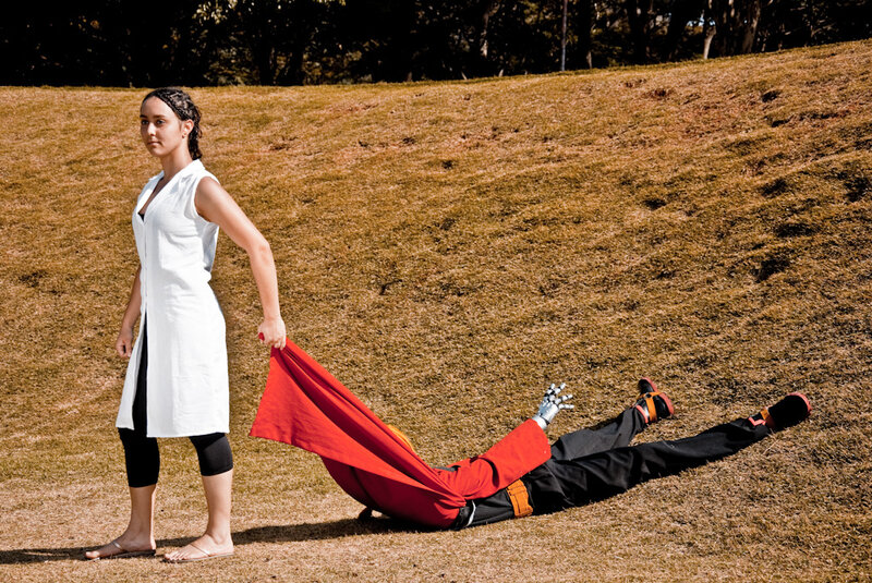 Woman dragging a figure on grass