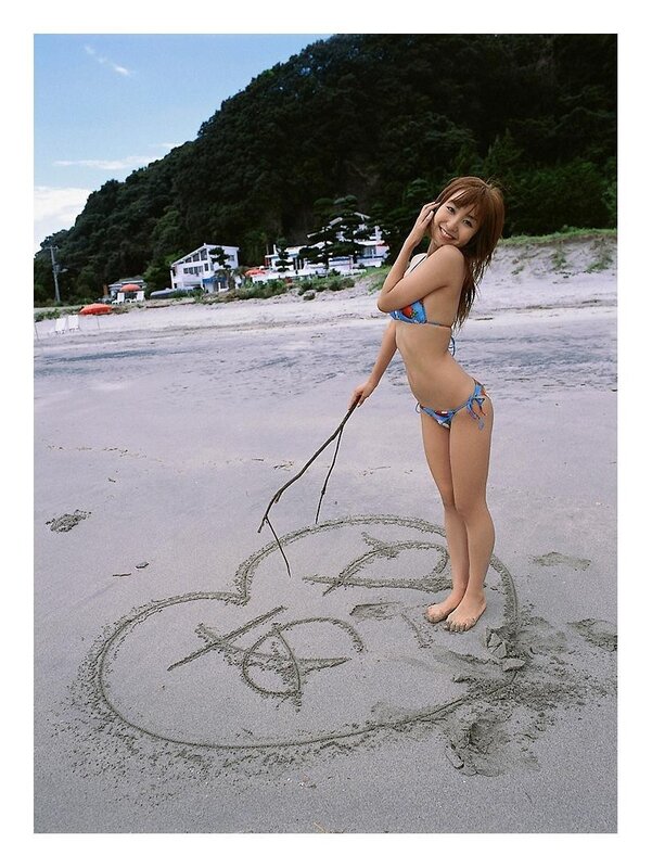 Woman drawing in the sand