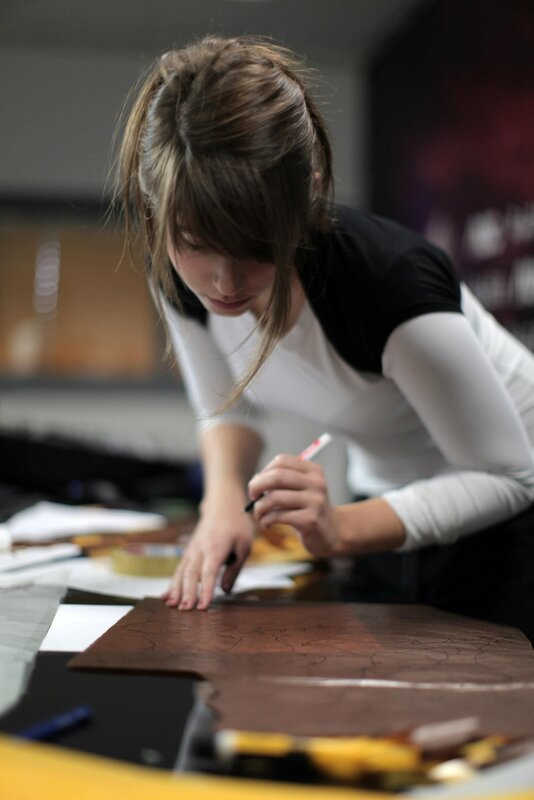woman drawing on wooden surface