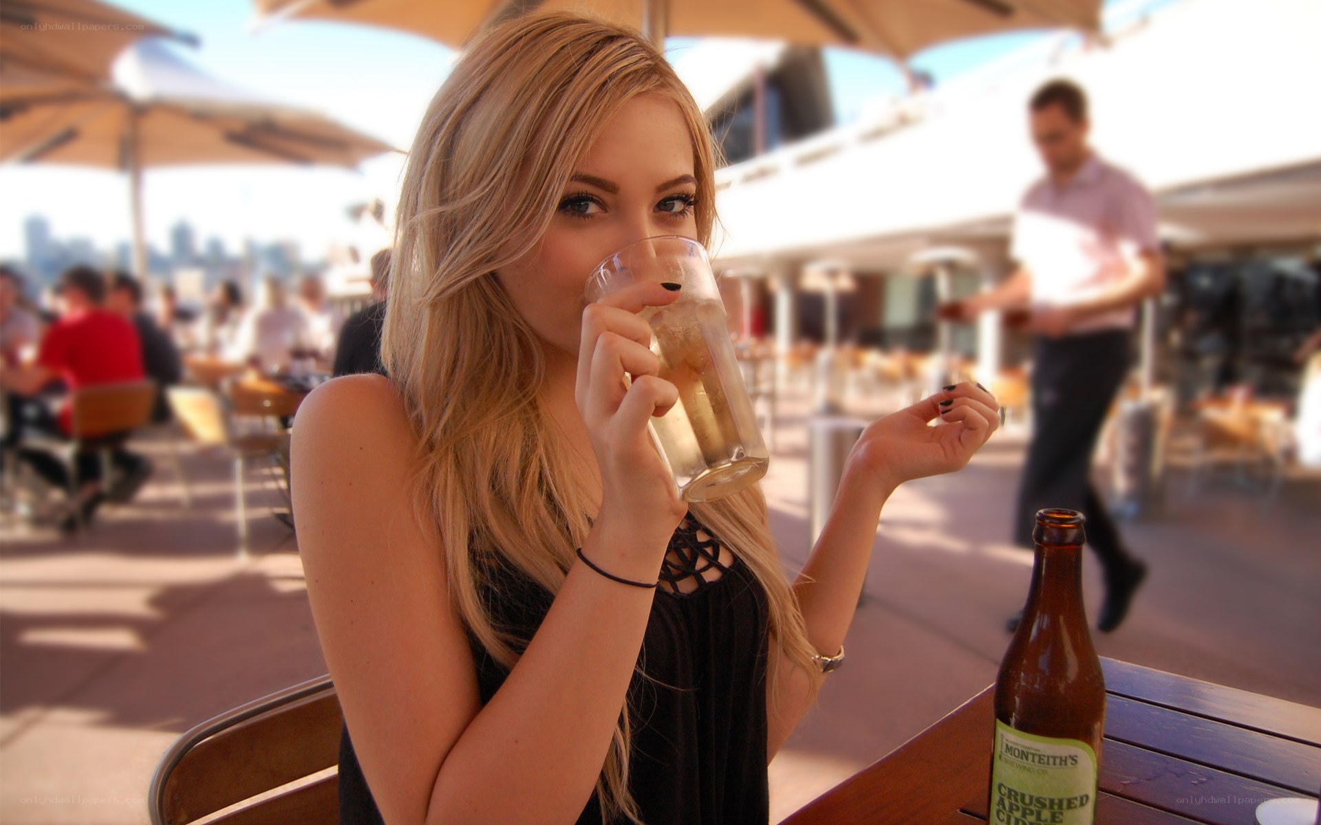 Woman drinking at outdoor cafe