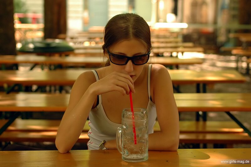 Woman drinking at outdoor table