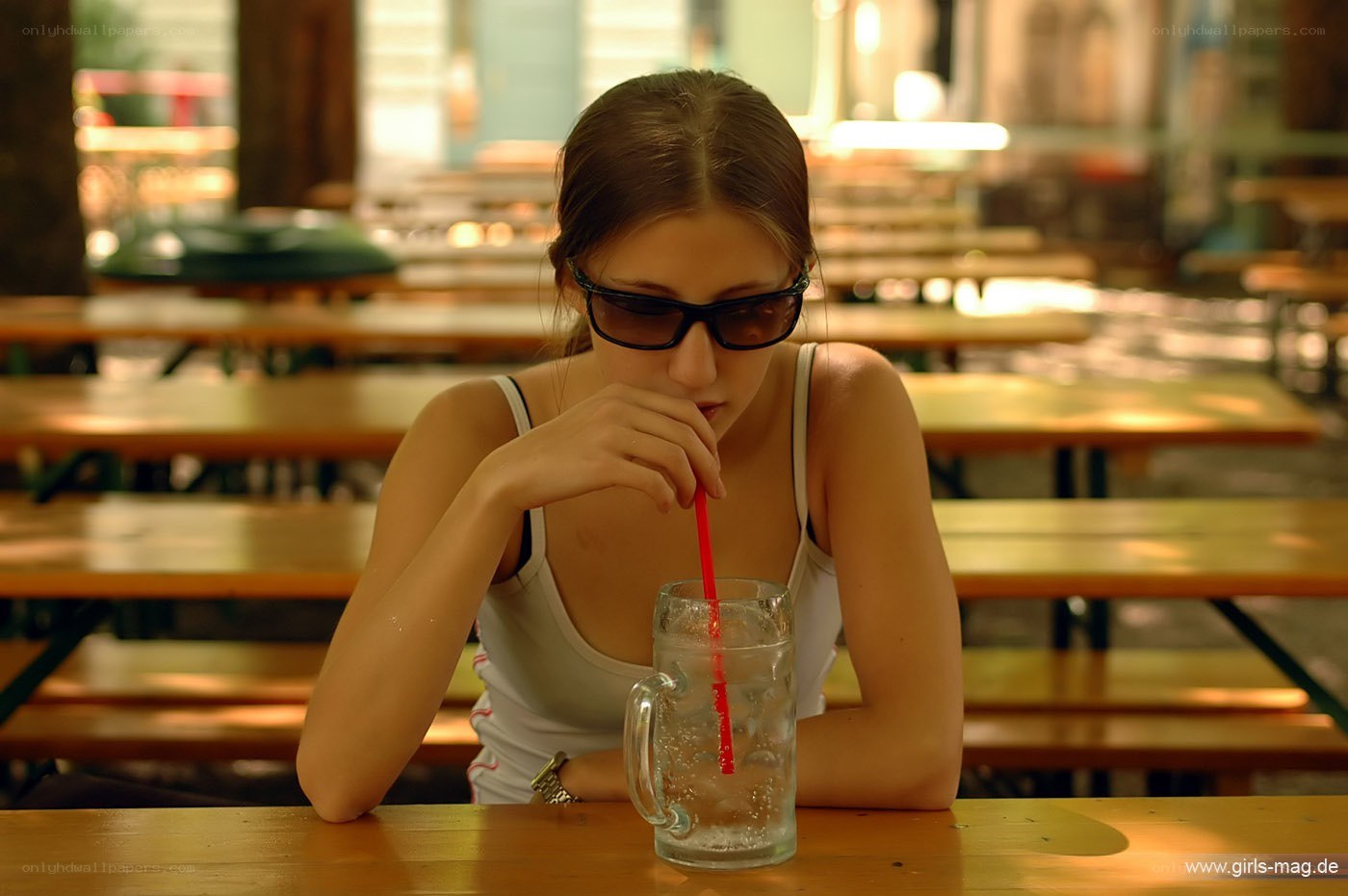 Woman drinking at outdoor table