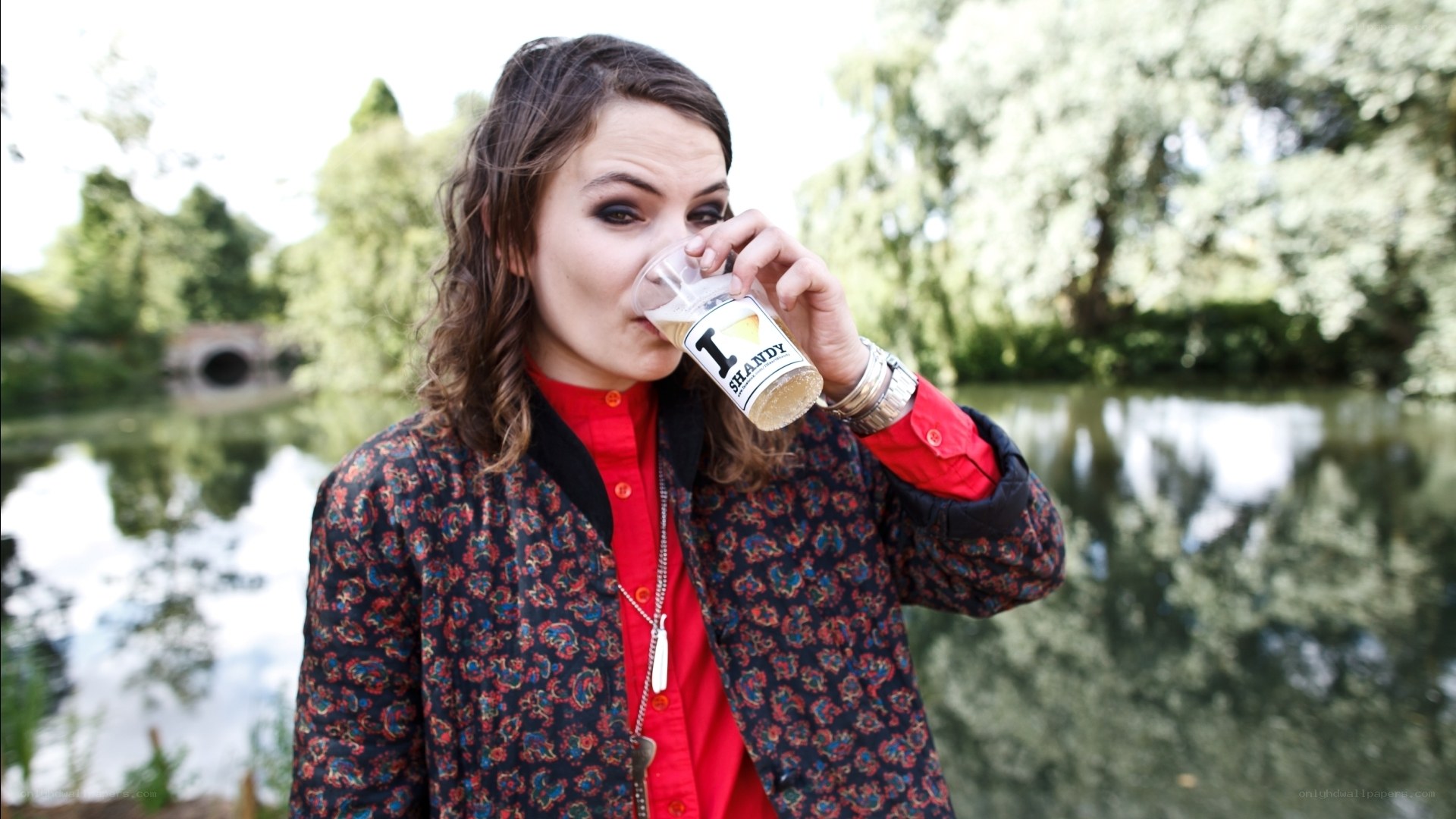 woman drinking beer outdoors
