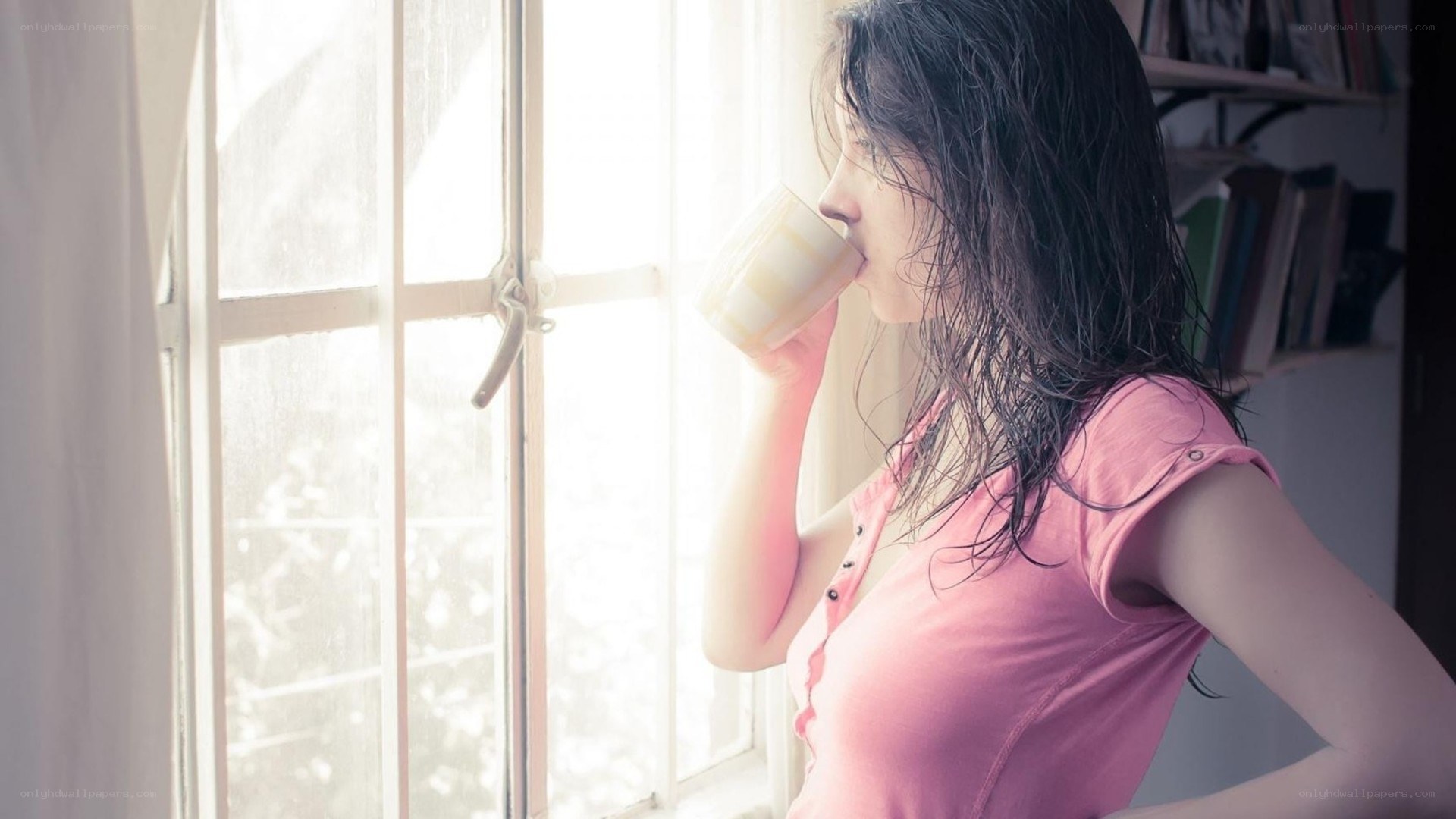 woman drinking by window