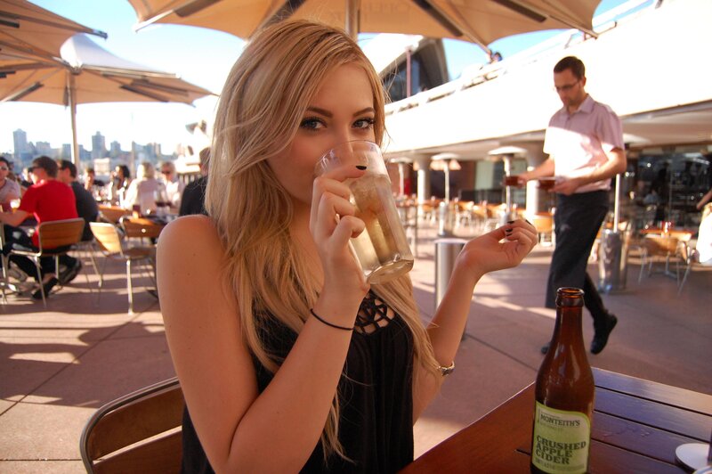 Woman drinking cider at outdoor cafe