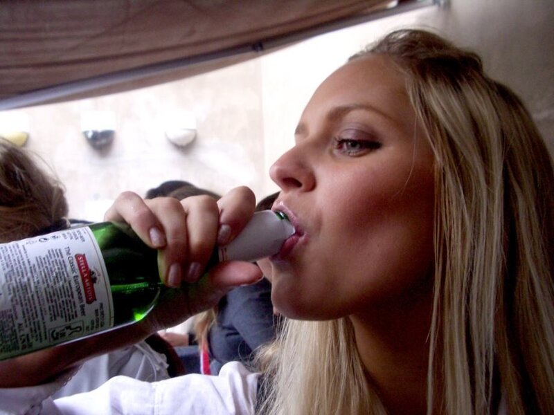 woman drinking from a bottle