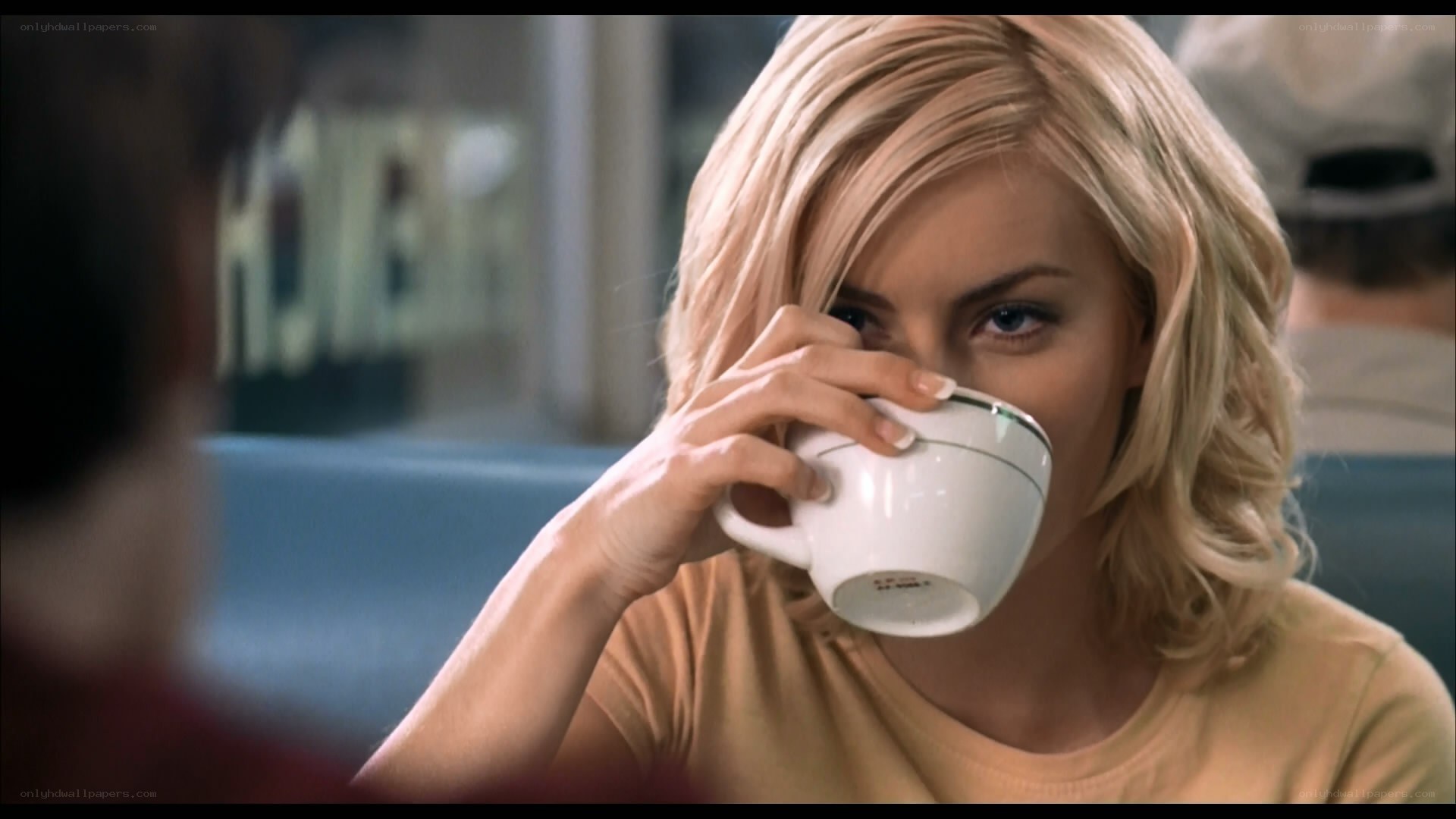 woman drinking from a cup