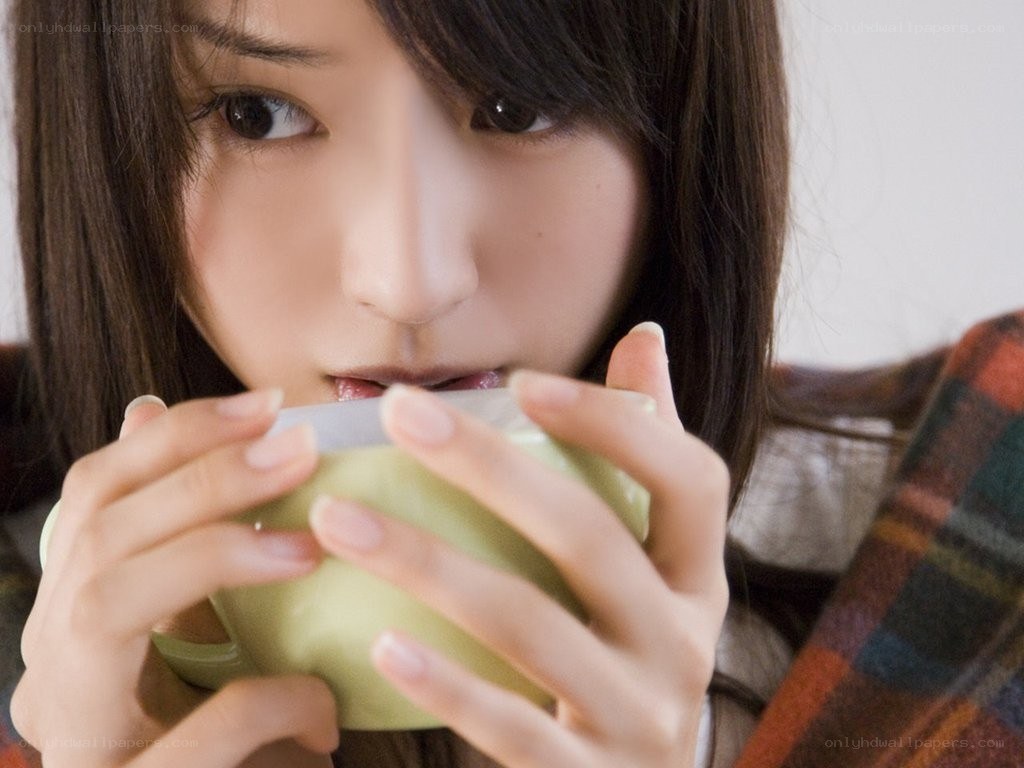 woman drinking from a cup