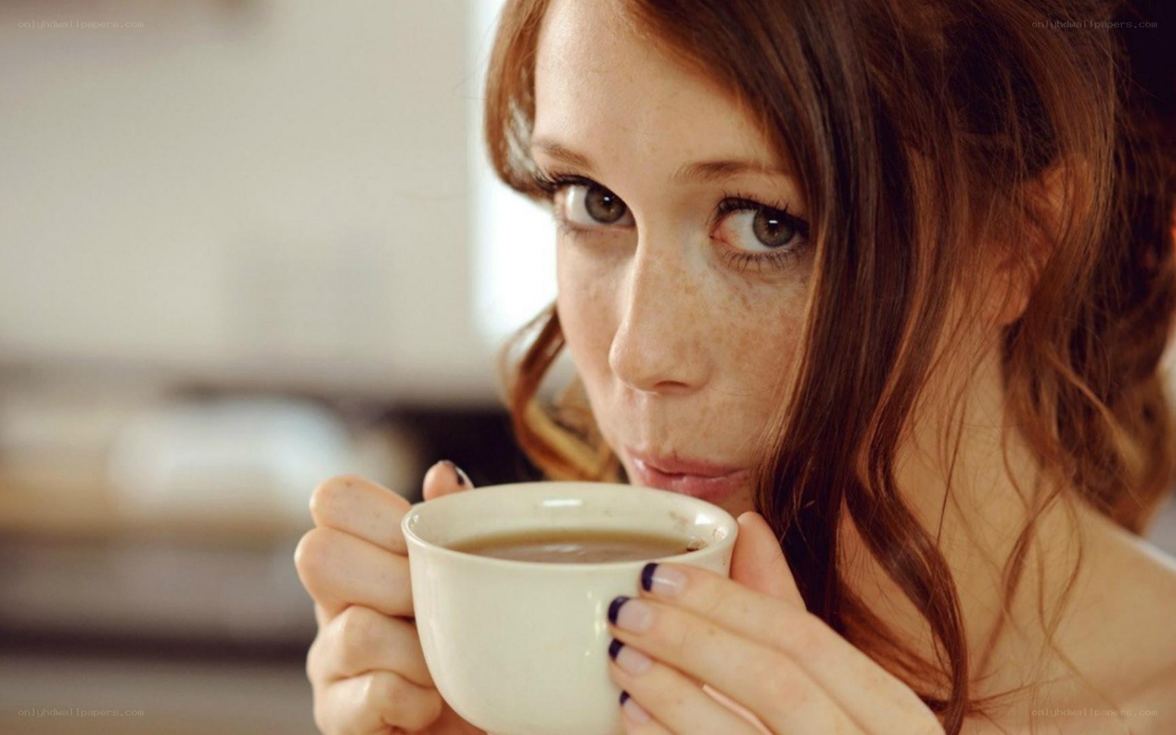 woman drinking from a cup