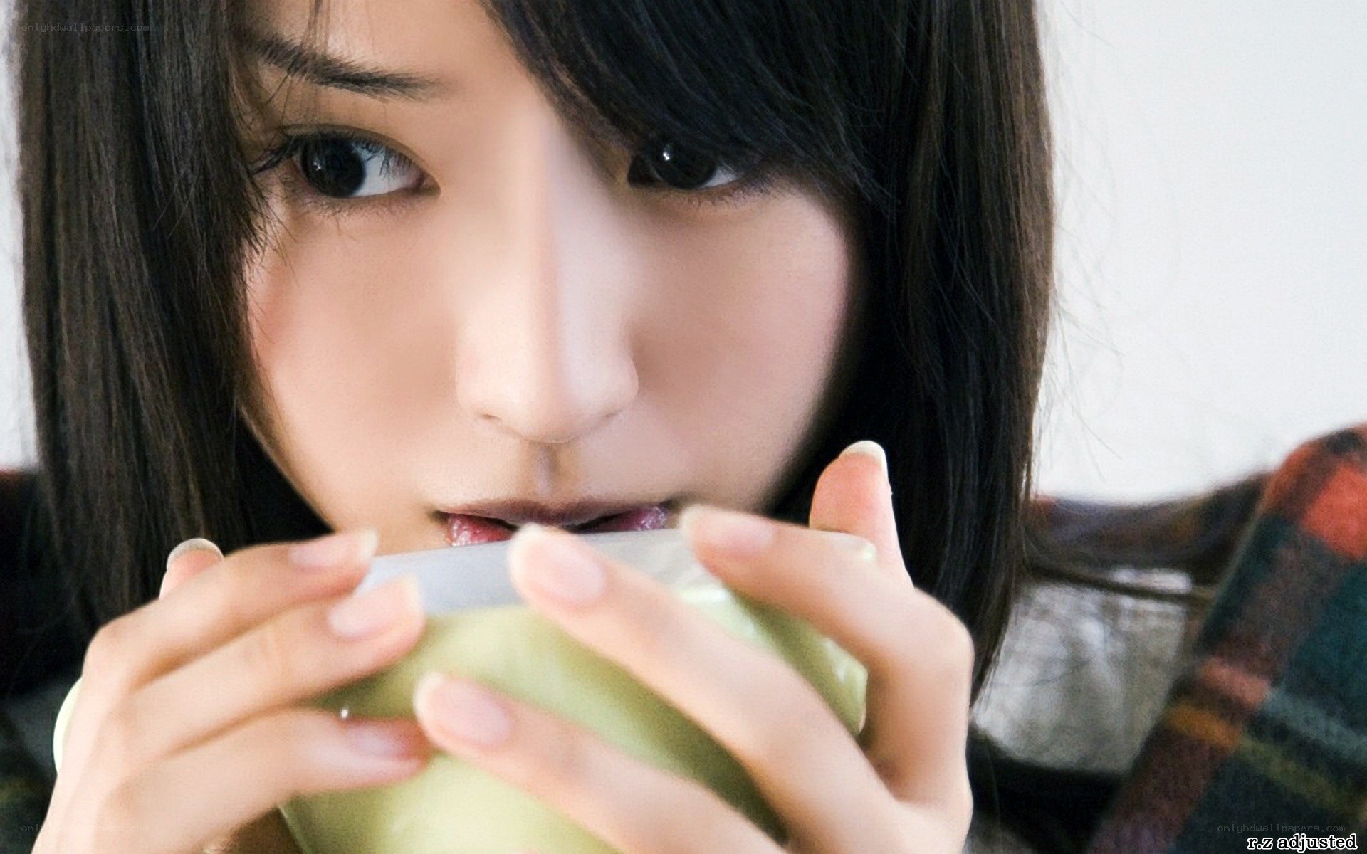 woman drinking from a cup