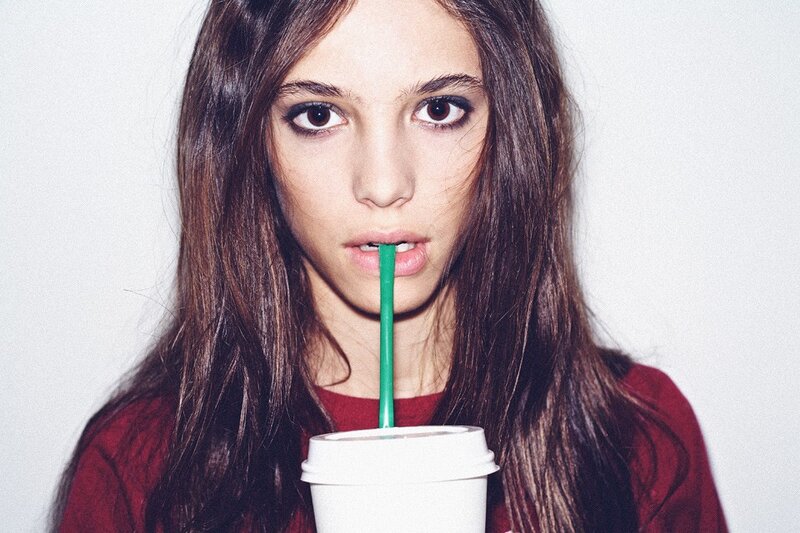 woman drinking from a cup