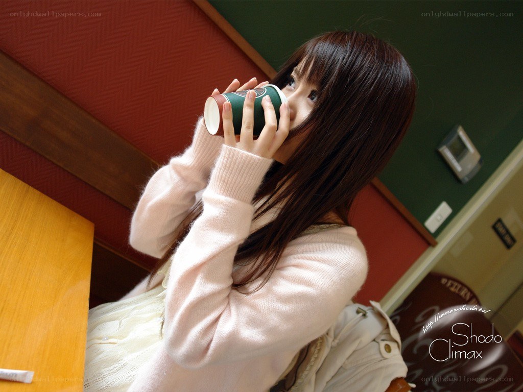woman drinking from a cup