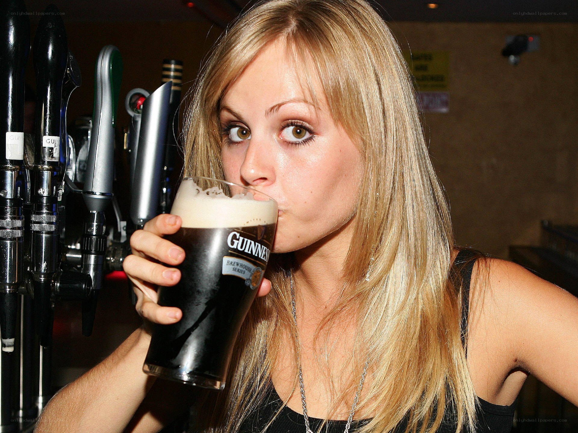 woman drinking guinness beer