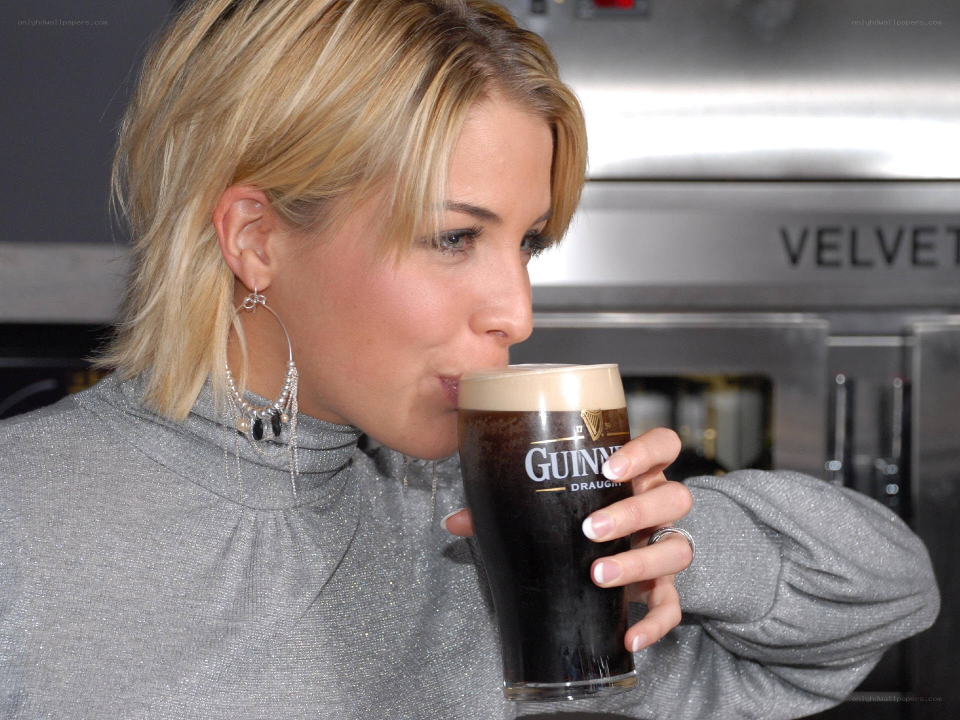 woman drinking guinness beer