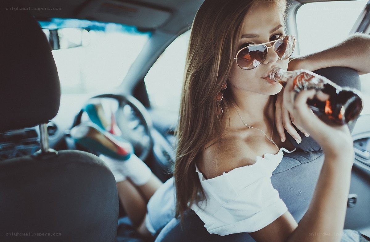 Woman drinking in car