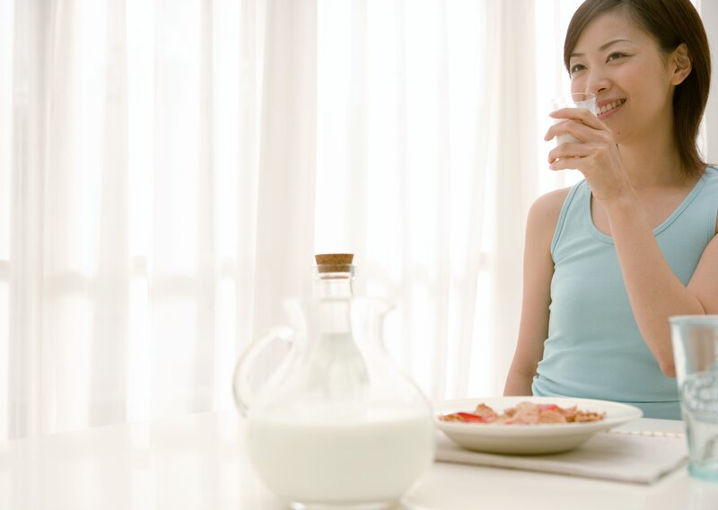 woman drinking milk at breakfast