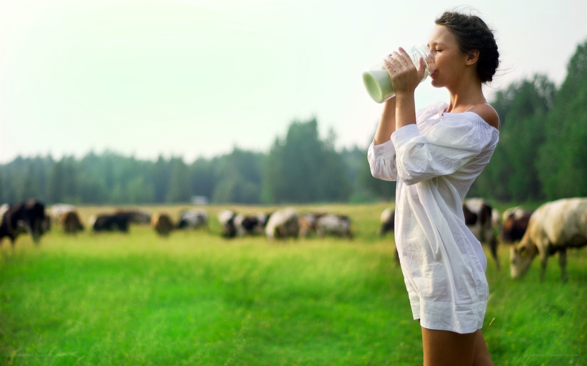 woman drinking milk in field