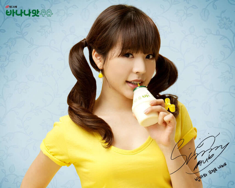 woman drinking milk in yellow shirt