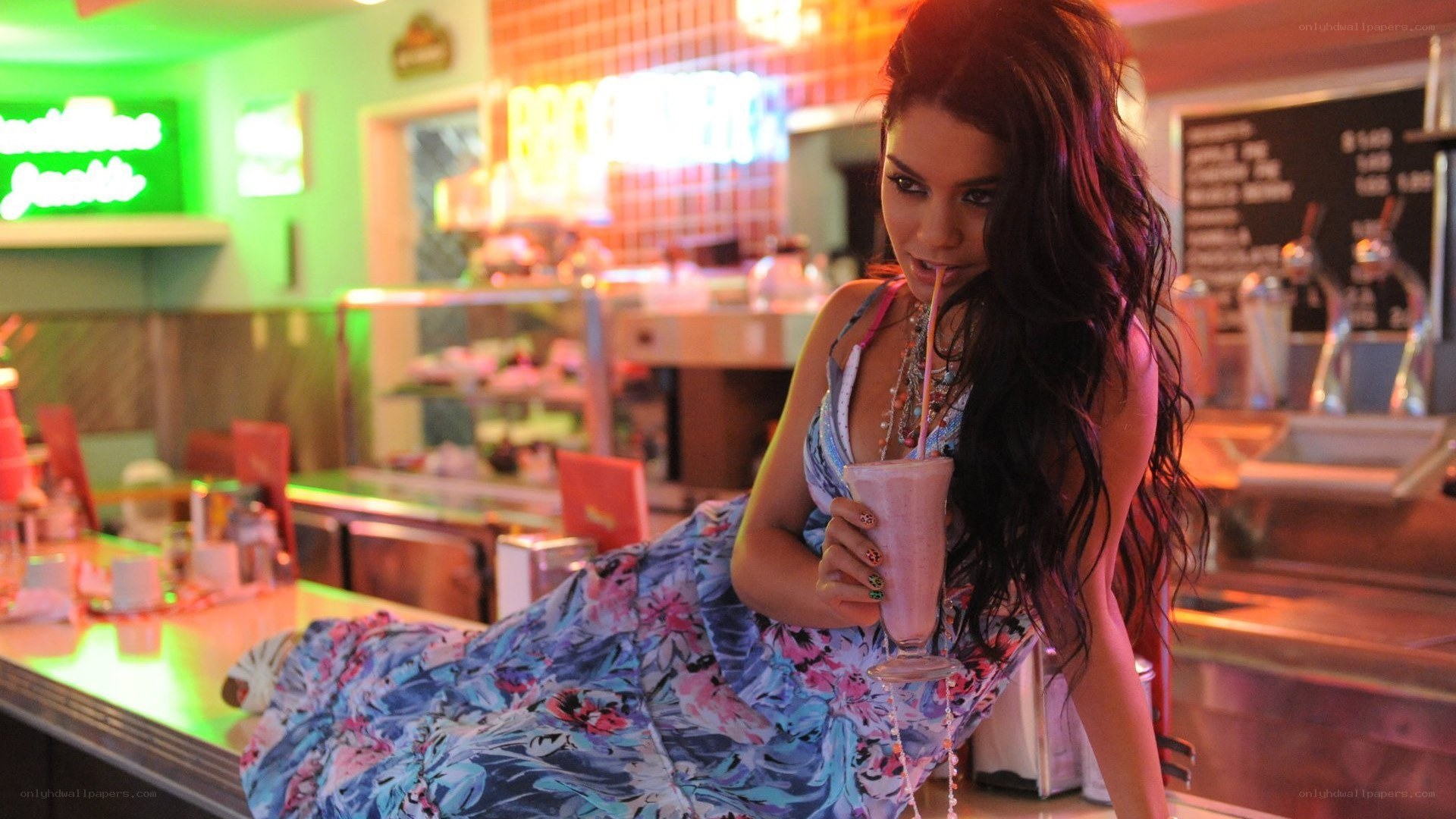 woman drinking milkshake at diner