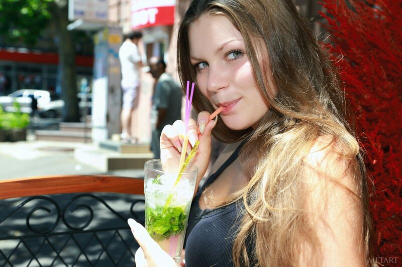 Woman drinking mojito outdoors