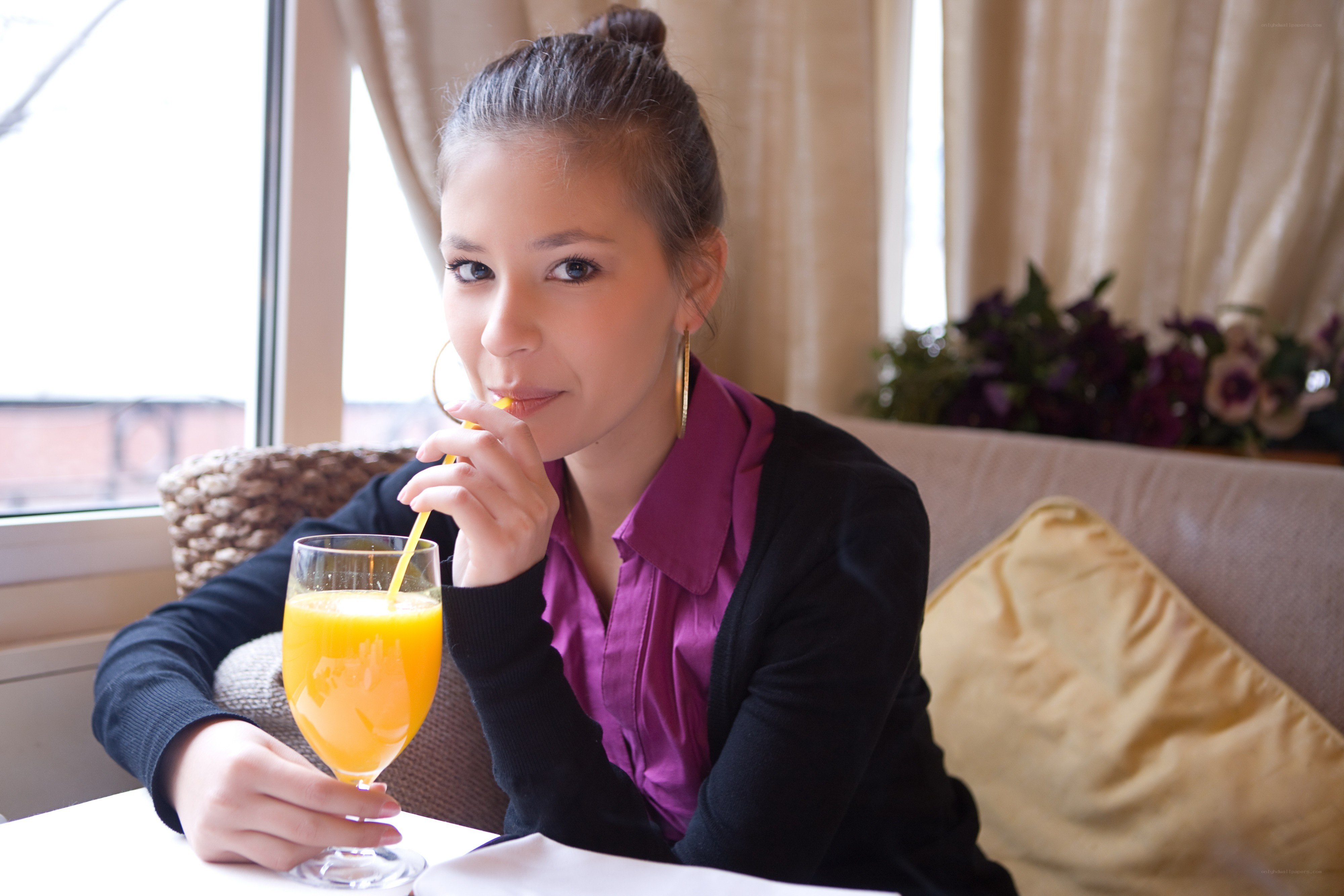 woman drinking orange juice