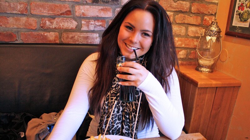 woman drinking soda at restaurant