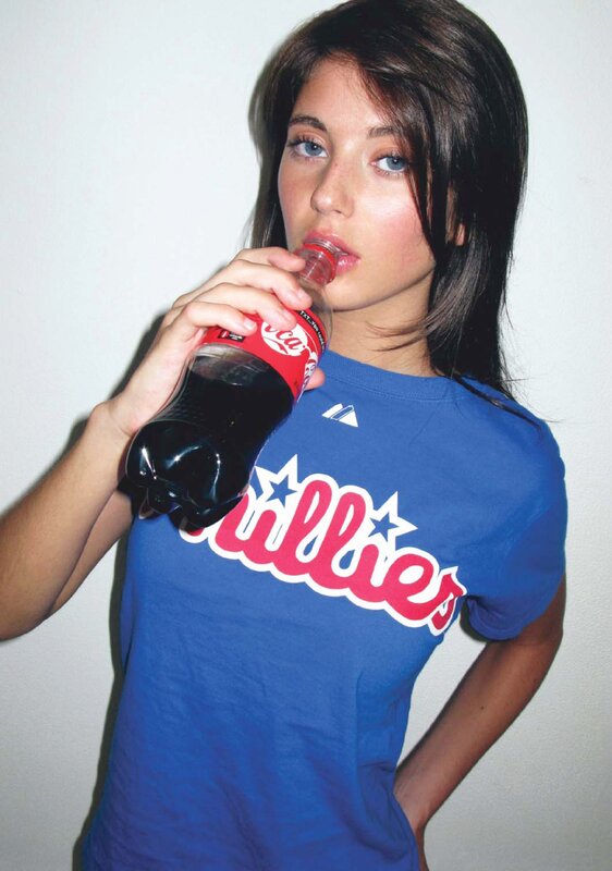 woman drinking soda in blue shirt