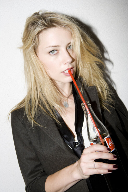 woman drinking soda with straw