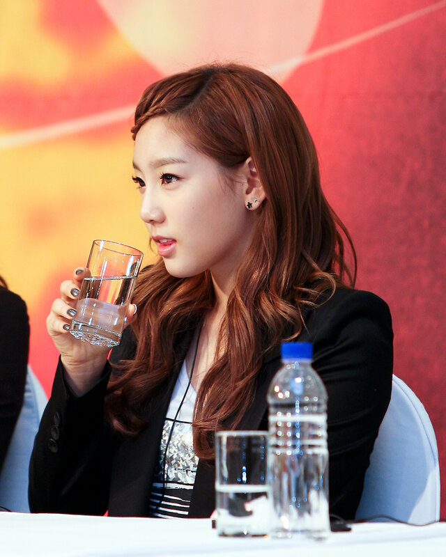 woman drinking water at event