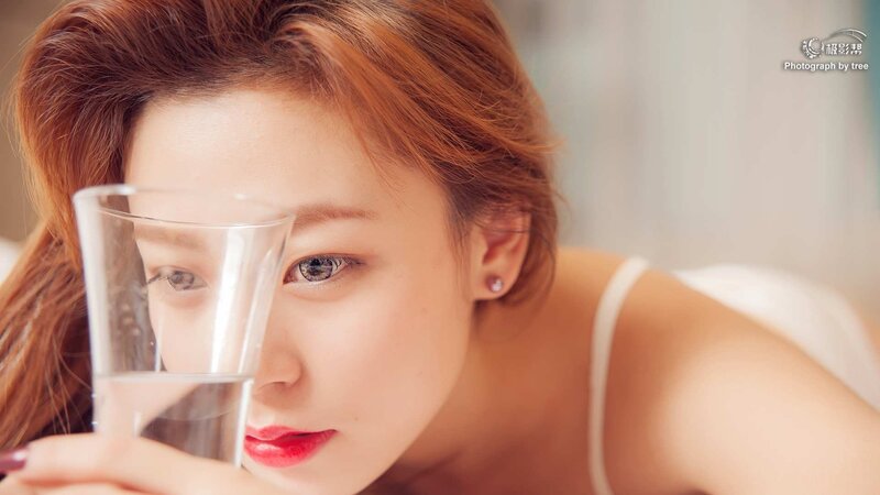 woman drinking water from glass