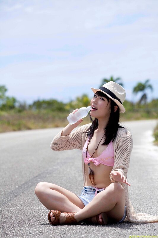 Woman drinking water on road