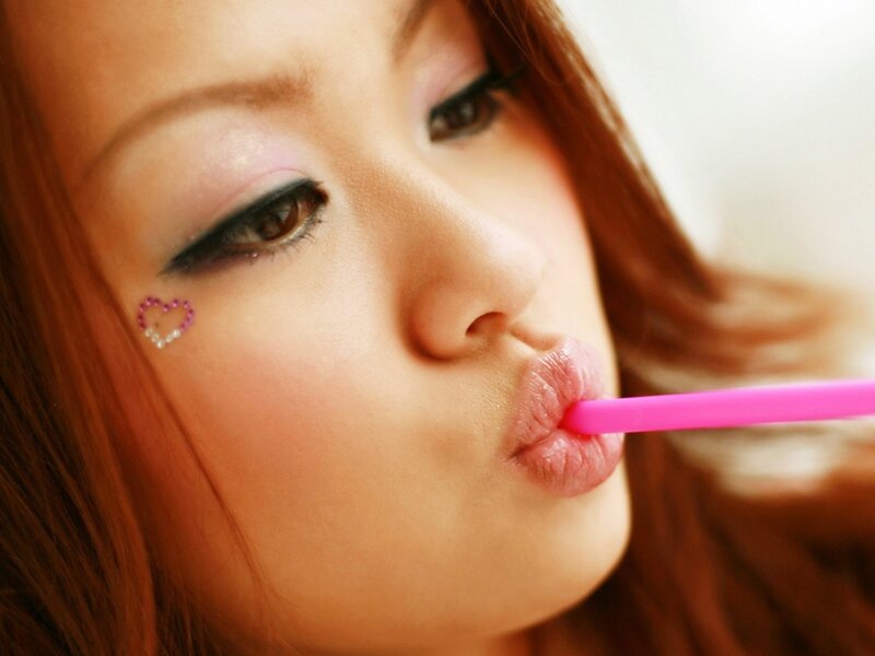 woman drinking with pink straw