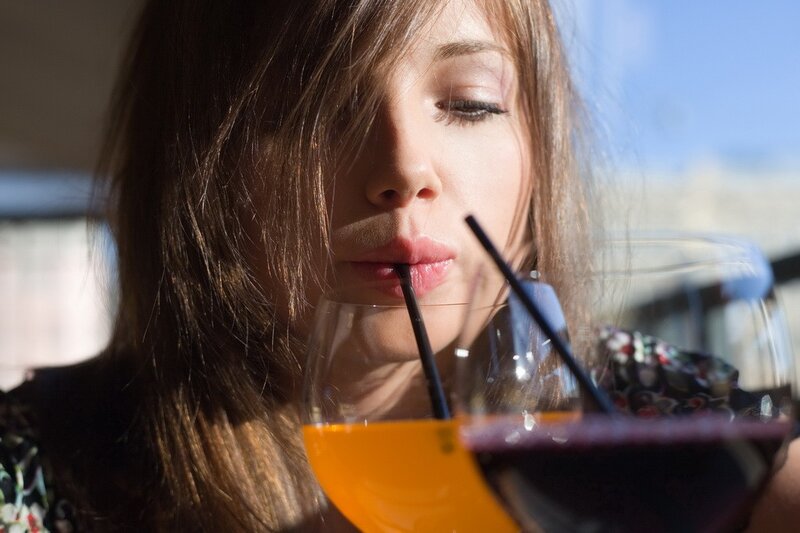 woman drinking with straws