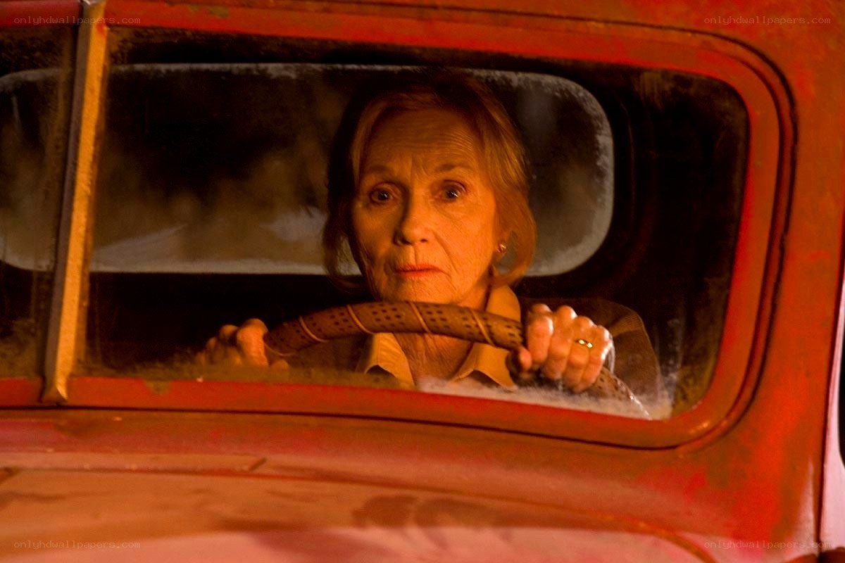Woman driving a red car