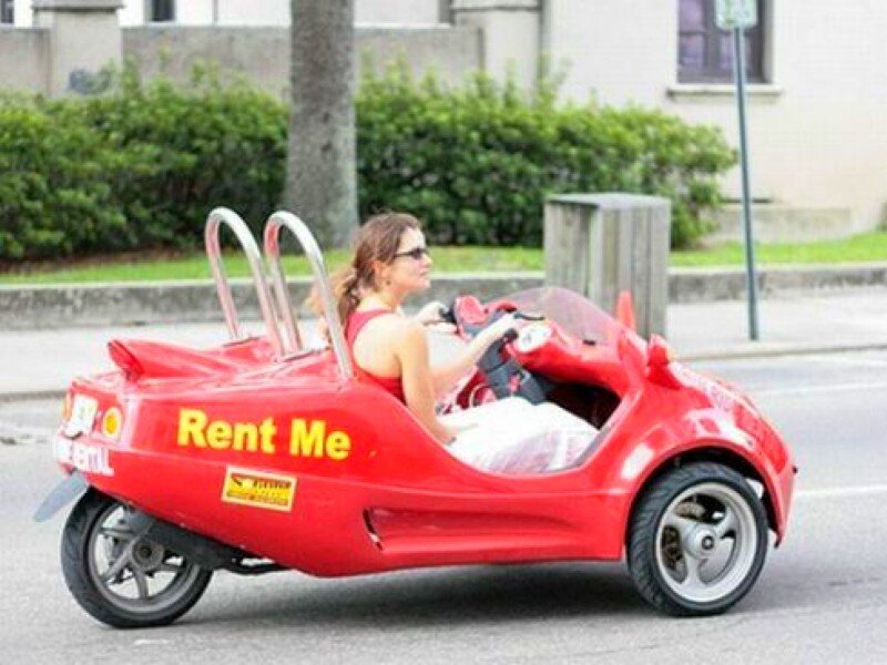 Woman driving a red rental car