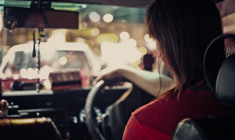 Woman driving at night